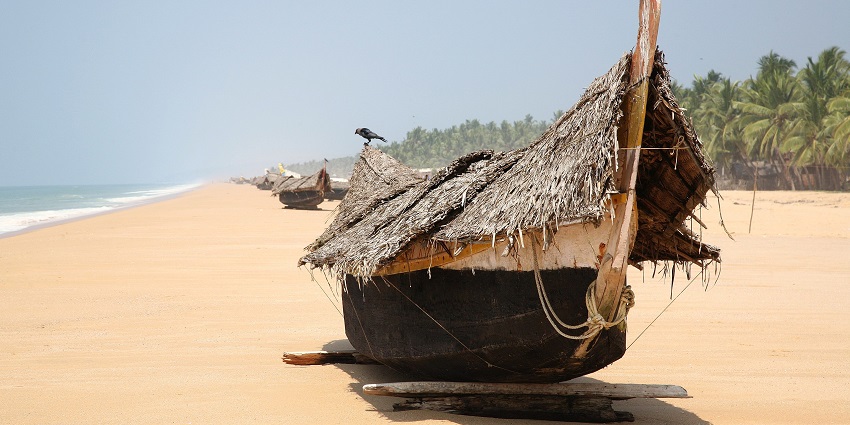 he view of Poovar beach and a boat - one of the best places to visit near Trivandrum