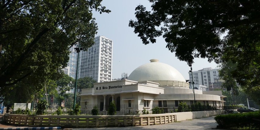 Birla Planetarium in Kolkata with dome structure and surrounding greenery.
