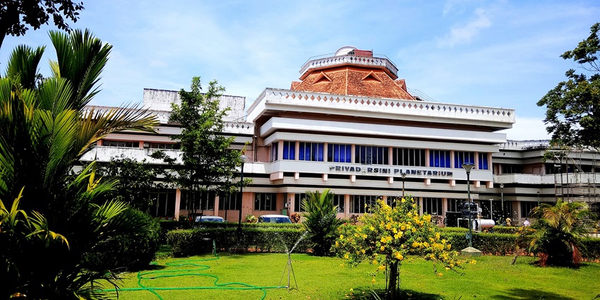 Exterior view of Priyadarshini Planetarium building surrounded by greenery in Thiruvananthapuram.