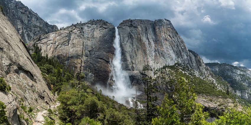 Thrilling mass of water coming down from the hills in the dense forest