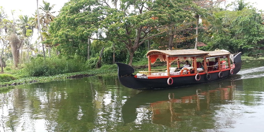 Houseboat at Punnamada lake, surrounded by lush green - places to visit in Alleppey