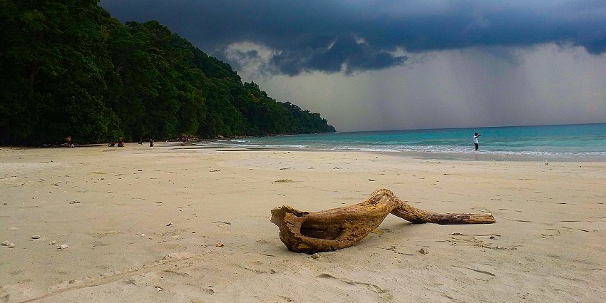 Breathtaking view of a beach with amazing views of rain clouds in the background