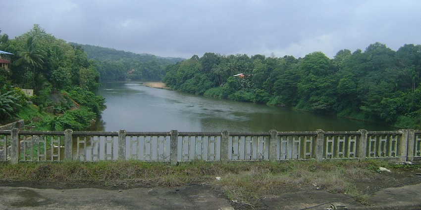 A view of the old collapsed Ranni bridge with the backdrop of the green forests