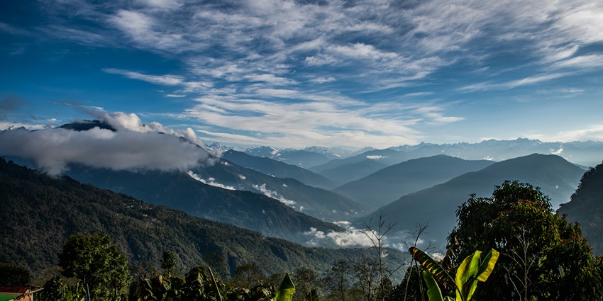 A breathtaking landscape of Ravangla adorned with towering mountains and lush greenery.