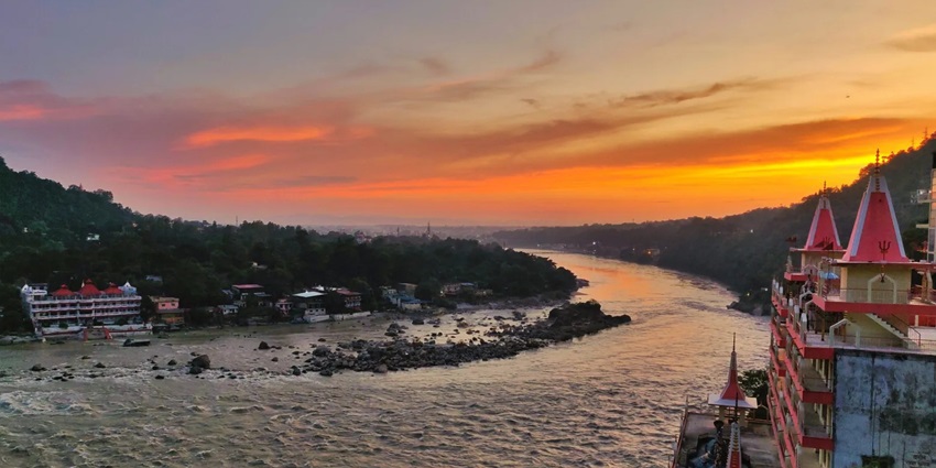 Scenic river view of Rishikesh, with serene waters - places to visit in summer in India