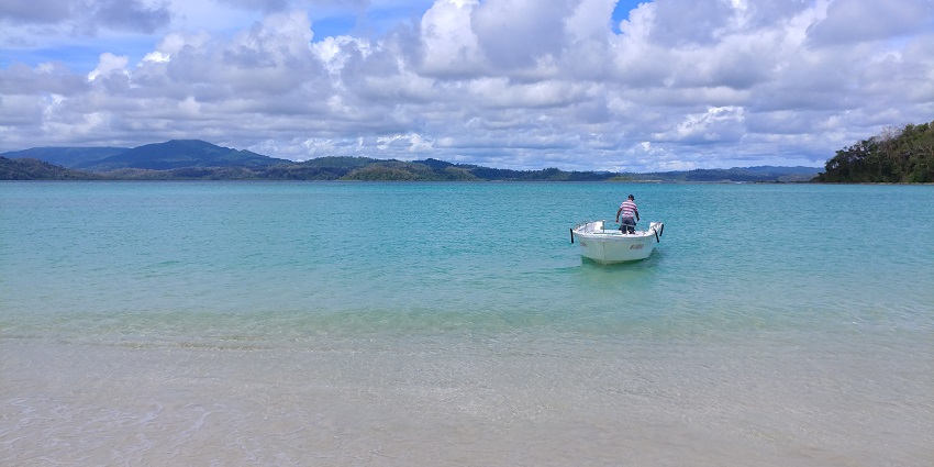 A boat on blue water-one of the most popular places to visit in Andaman for honeymoon.