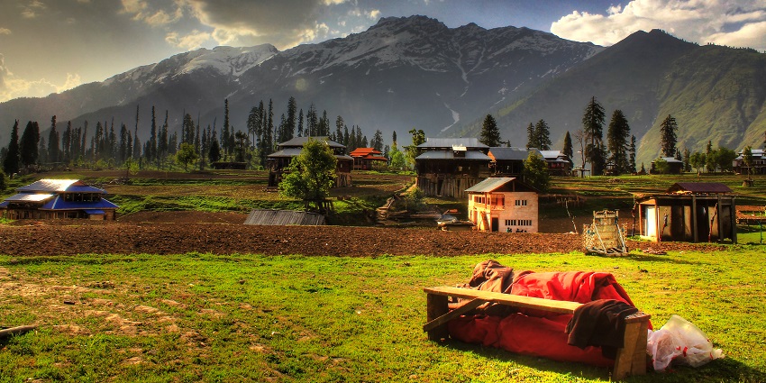 A view of the picturesque meadows of Kashmir with the mountains in the backdrop