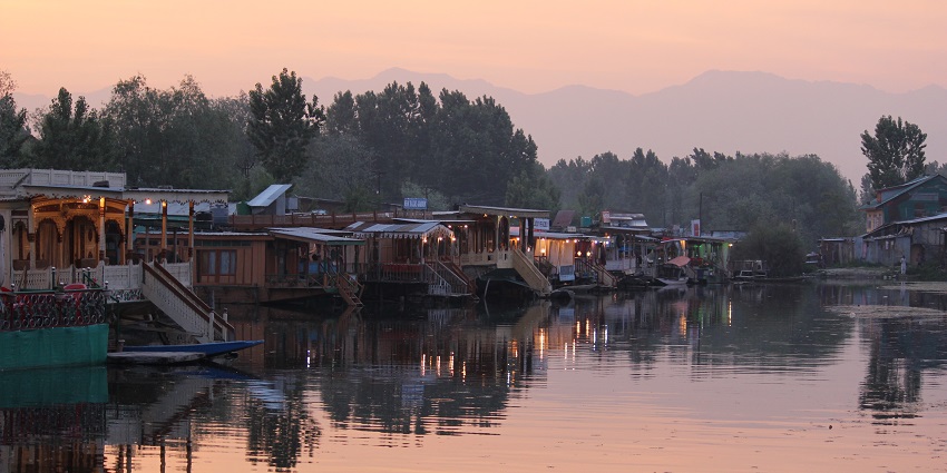 Evening view of houseboats on Dal Lake, one of the places to visit in Srinagar in summer.