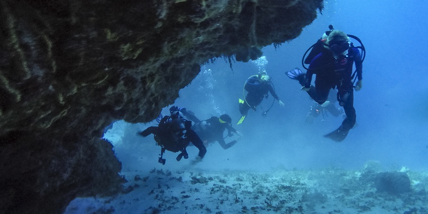 Divers exploring under water cave - Water sports in Varkala, Kerala