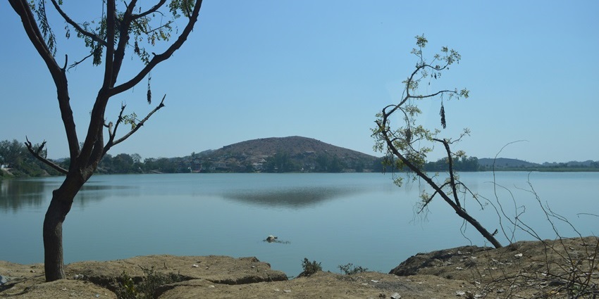 A mesmerising view of Sehrabal Lake featuring shimmering blue waters and greenery.