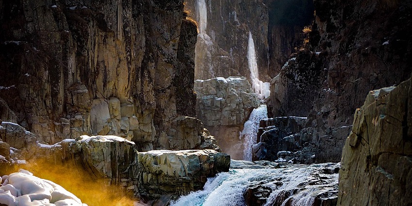 A stunning visual of clear water spring cascading through rocky terrain in Kashmir.