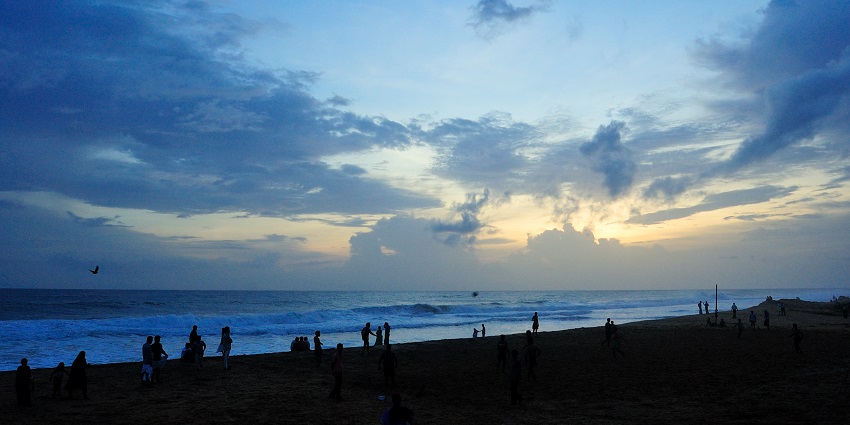 Sparkling waves crashing at the shores of Shanghumukham beach at dawn, a picturesque view