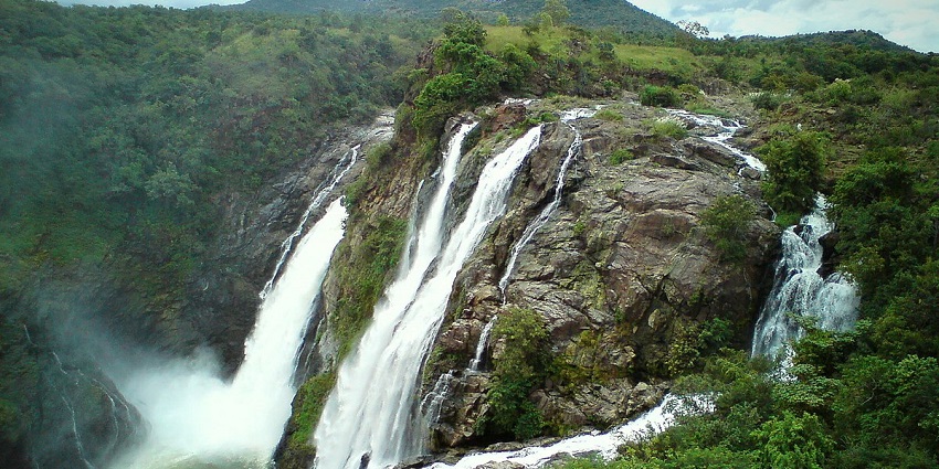 Magnificent Shivanasamudra Falls, splitting into two cascading segments amid greenery