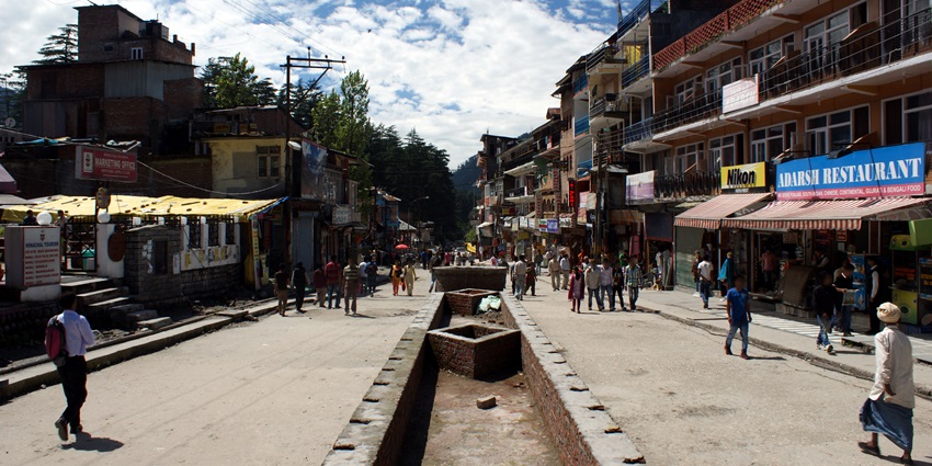 Image of market around the hills where people are strolling around -things to do in Manikaran