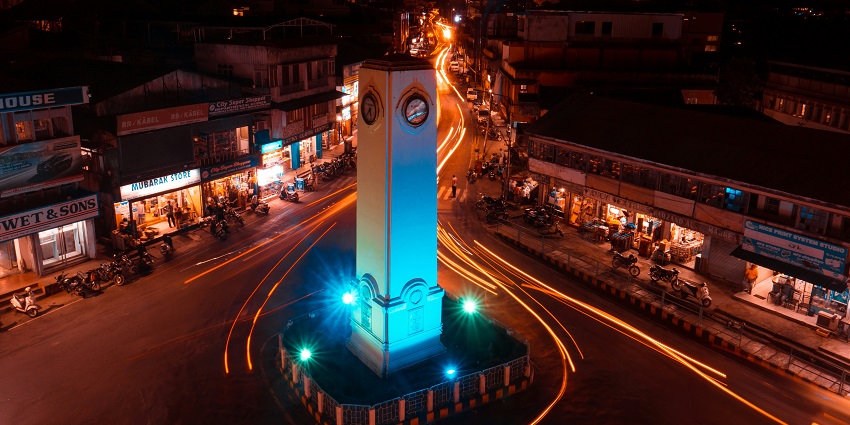 A tall clock tower sitting in the middle of a street