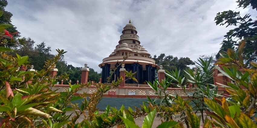 A captivating view of the Sivagiri Mutt with lush greenery and a backdrop of cloudy skies