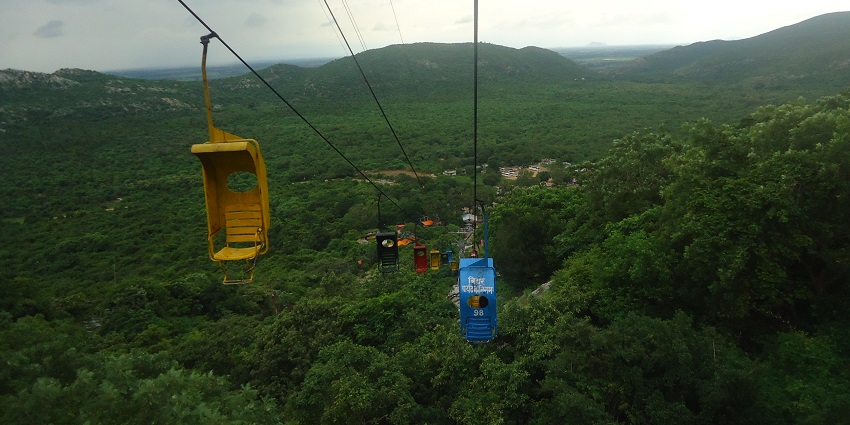 An image of a ropeway ride offering panoramic views of beautiful landscapes in India.