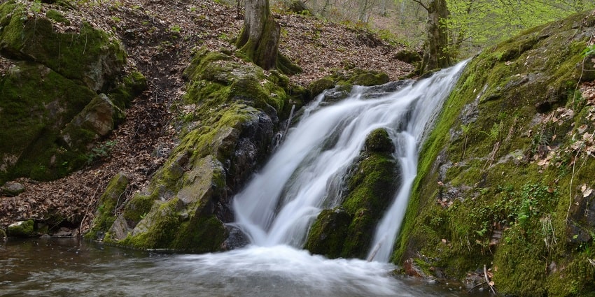 A breathtaking view of waterfalls with free-flowing water falling down the rocks.