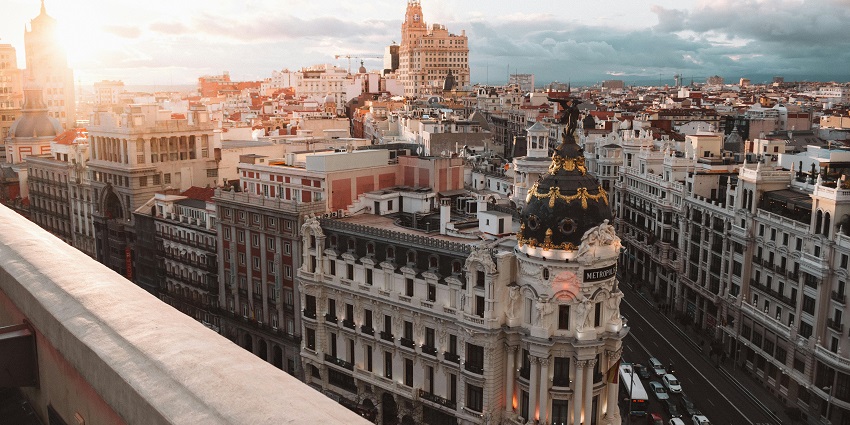 Photo of Madrid city during dawn with buildings boasting historical architecture