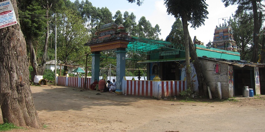 A side view of the Sree Rama Swami Temple with a lot of people sitting in the front.