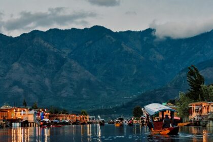 Scenic view of Dal Lake in the foreground and popular Srinagar temple you can visit.