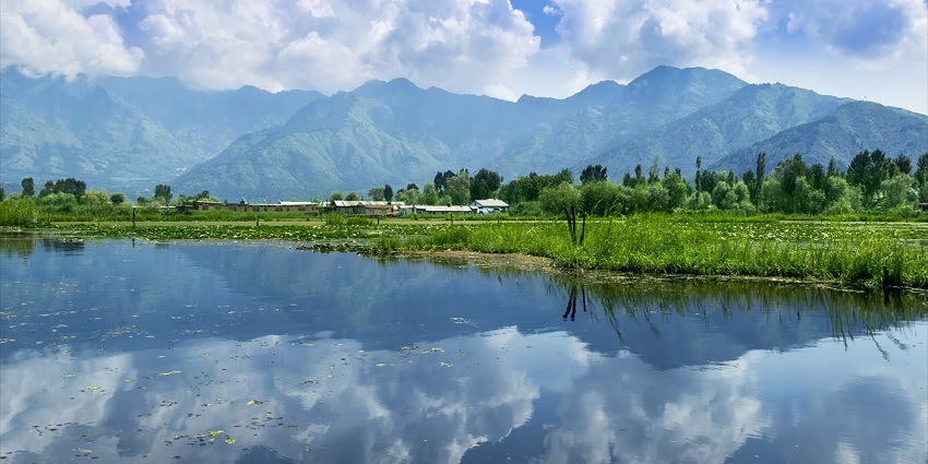 Reflection of scenery on Dal Lake, one of the best places to visit in Kashmir in October.