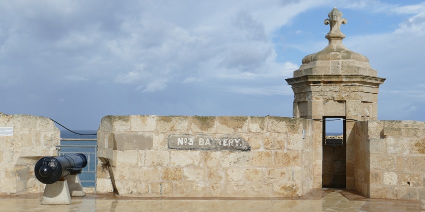 View of a canon places at the top of St. Angelo’s Fort with a background of cloudy sky