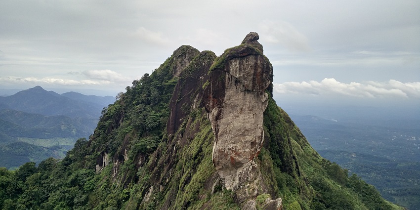 Magnificent view of Illikkal Kallu, a unique stone hill against a clear blue sky.