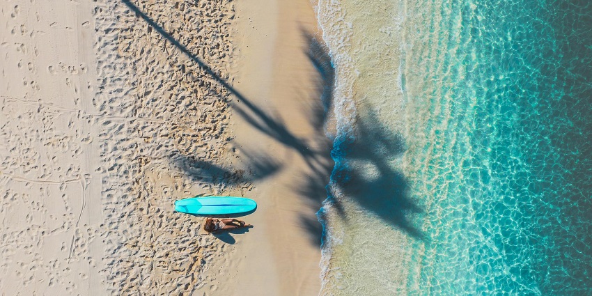 A woman sunbathing on the beach, one of the best activities to do in this Island.