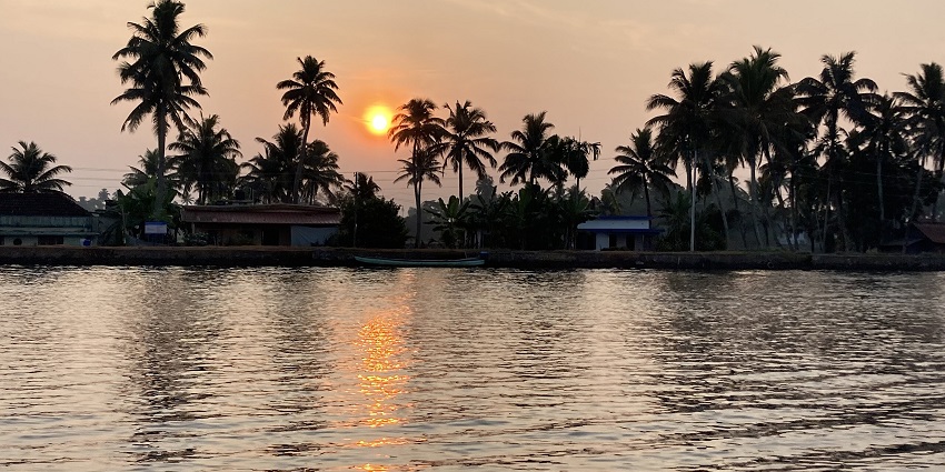 Sunrise hues dancing on the sparkling backwaters of Alappuzha offering a scenic view