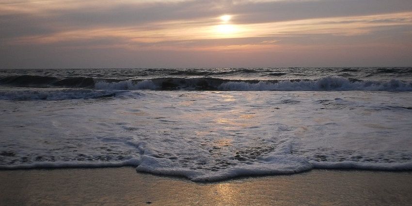 Mesmerizing sunset at the Cherai beach with the waves crashing the golden shores