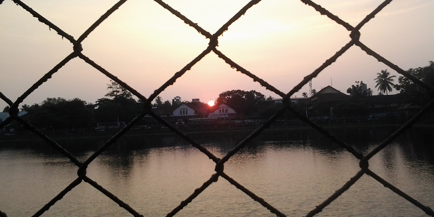 Sunset casting a golden glow, tranquil water - places to visit near Vilangad village