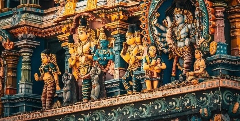 A colourful view of a temple in Kerala with statues of many Hindu gods and goddesses.