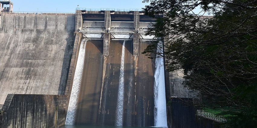 Dam with its expansive reservoir near waterfall - one of the best waterfalls in Kollam