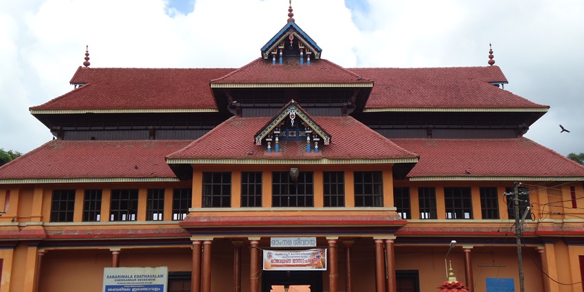 A frontal view of a traditional Hindu temple with multiple pillars standing tall around the entrance