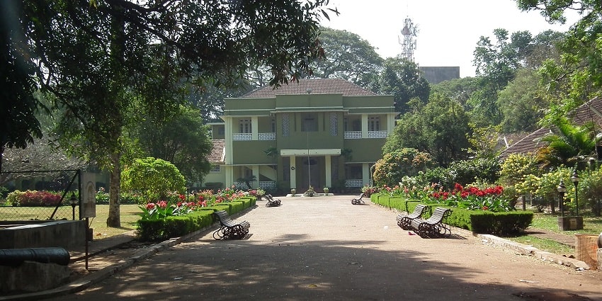 A scenic view of Thrissur Zoo & Museum with lush green trees and gardens on the entrance