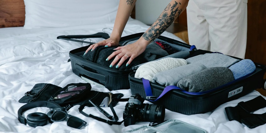 Traveller packing a bag with essentials - things to pack for Kayaking in Havelock Island
