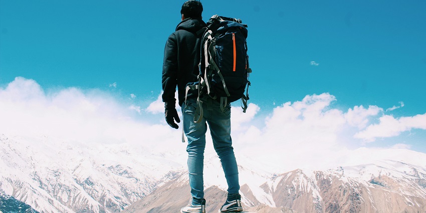 Photo of Man Standing On Top Of Mountain - pack essential items for the trip to the temple