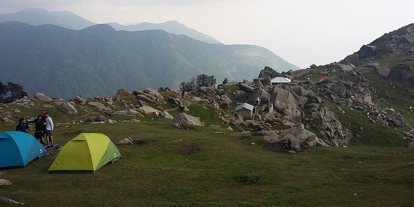 Enjoy panoramic views of the Dhauladhar range on Triund Trek in Himachal Pradesh, India.