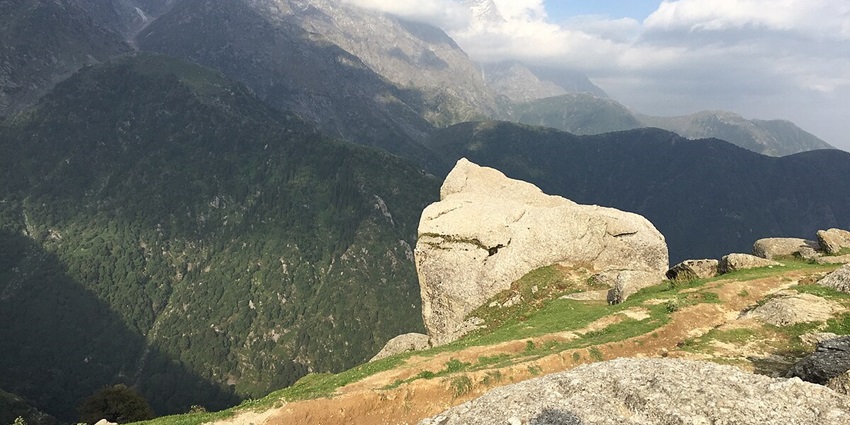 Breathtaking view of lush green mountains from the top of Triund Hill in Himachal Pradesh