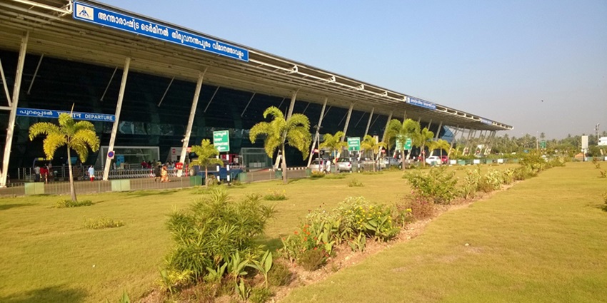 A scenic view of a terminal at Trivandrum Airport with lush greenery outside the premises