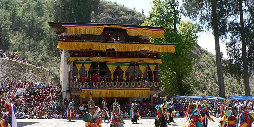 A festival dance at Rumtek Monastery with spectators in the background