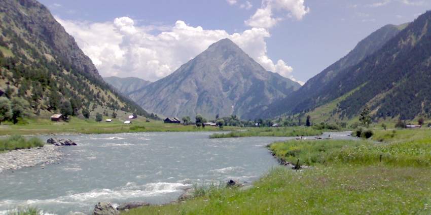A breathtaking landscape of a stream passing through enormous mountains of Gurez Valley.