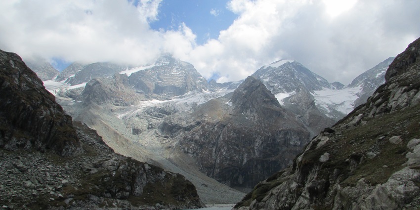 An enchanting view of the Tulian Lake paving its way through the towering mountains.
