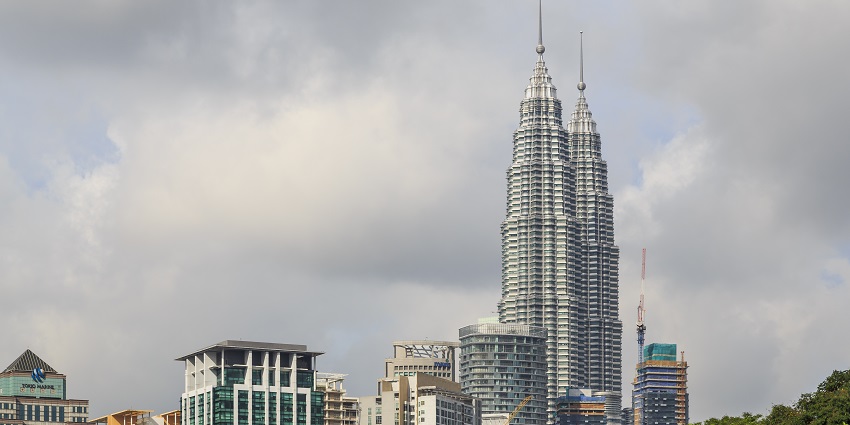 Twin Towers shining brightly against the night sky - places to visit in Kuala Lumpur