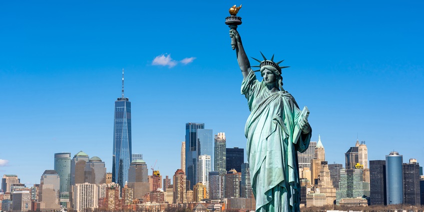 A captivating daytime view of the sky-high Statue of Liberty with clear sky in background