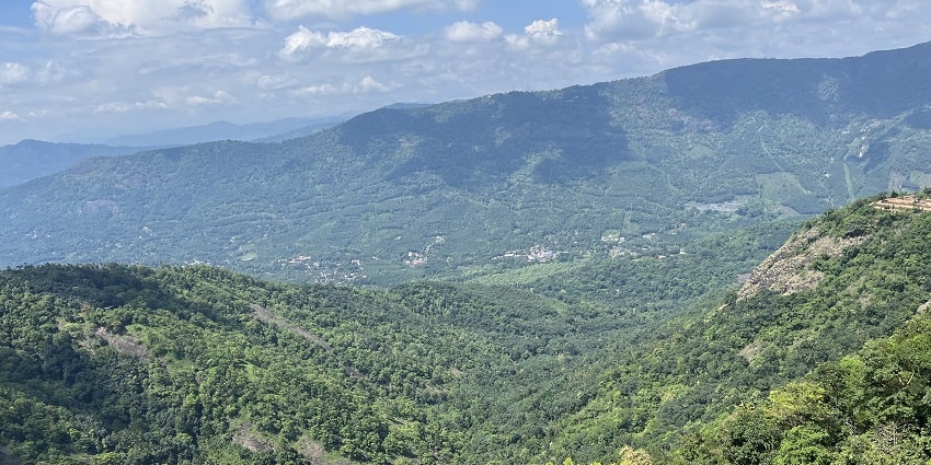 Cherish the mesmerizing view of Vagamon Hills near Vellappara Waterfalls, Kerala.