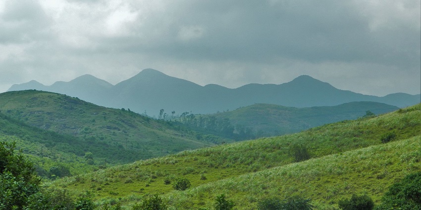 Verdant fields of the Vagamon view point, looking over the Western ghats far beyond