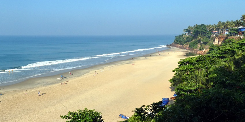 Cliffside aerial view of Varkala Beach with golden cliffs and turquoise ocean waves