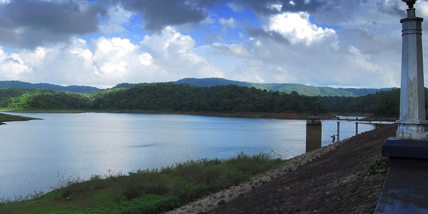 Vazhani Reservoir's calm waters with surrounding greenery - near Peechi Wildlife Sanctuary
